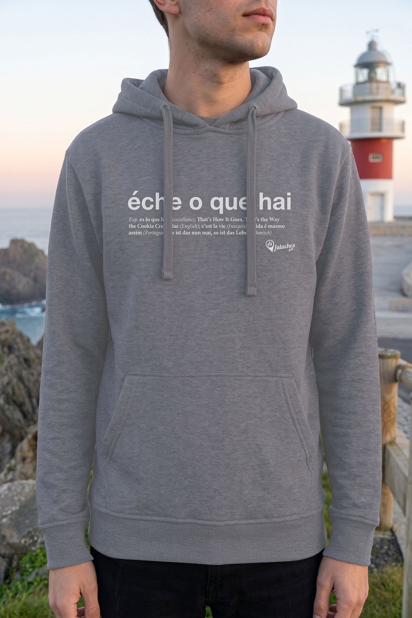 Primeiro plano do suadoiro Éche o que hai en gris claro posto por unha persoa, cun faro ao fondo